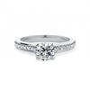 A beautiful round brilliant cut diamond ring with shoulder stones in platinum