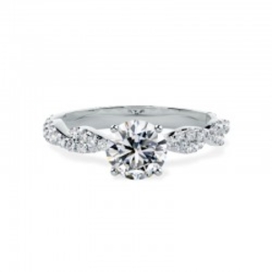 A beautiful round brilliant cut diamond ring with shoulder stones in platinum